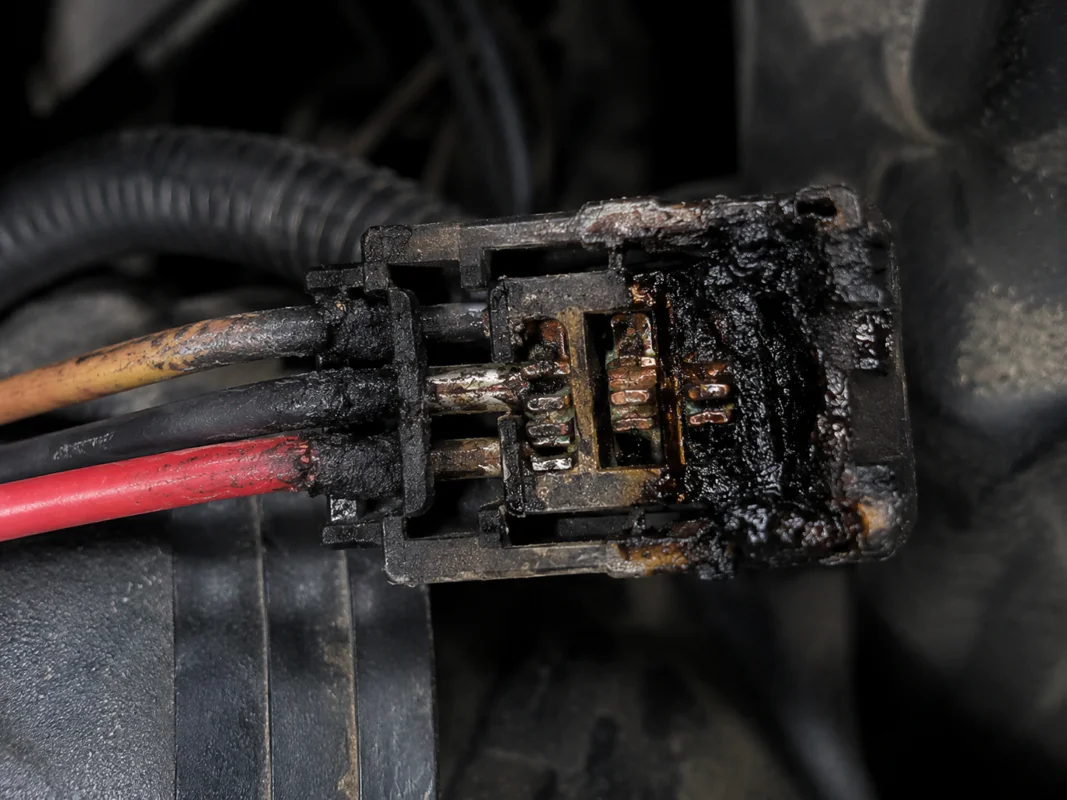 This connector is burnt from poor loose contact caused by vibration. Its plastic housing is charred, terminals oxidized and wire insulation damaged by high temperature.